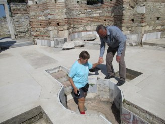 Sandie enters the baptism well at Basilica of St. John, Selcuk